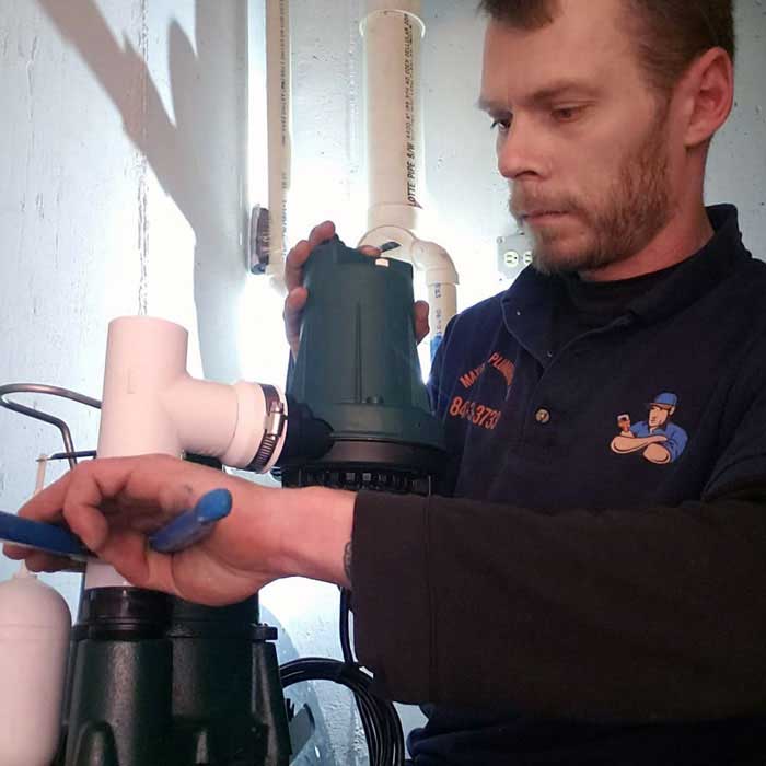 Plumber inspecting a residential sump pump system in Barrington, Illinois